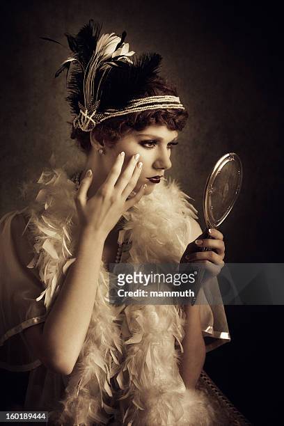 vintage style woman looking herself in a mirror - boa stock pictures, royalty-free photos & images