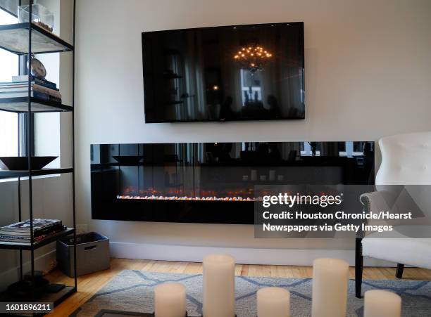 Jackie Traywick's living room, with a fake fireplace, in her condo at the St. Germain building, Wednesday, March 20 in Houston. Story on the Downtown...