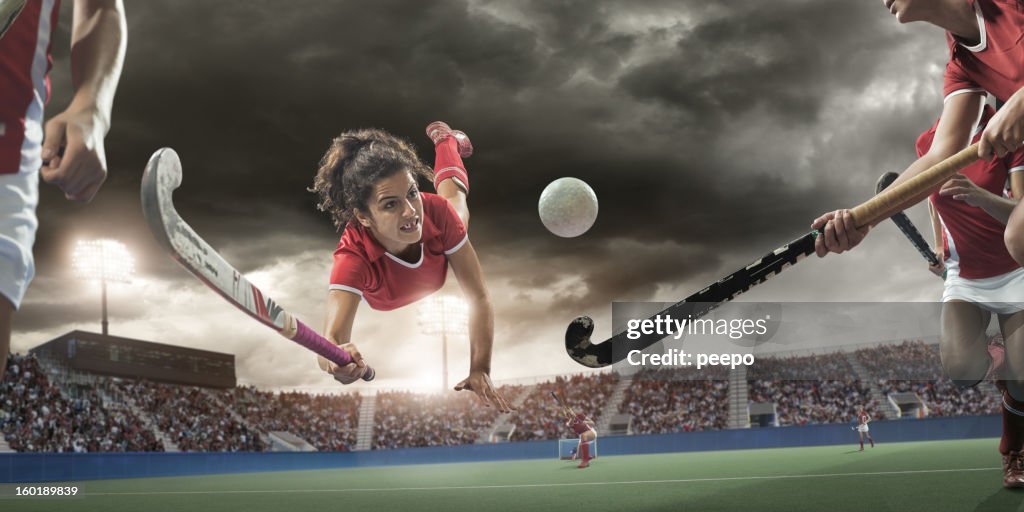 Field Hockey Player Diving to Hit Ball