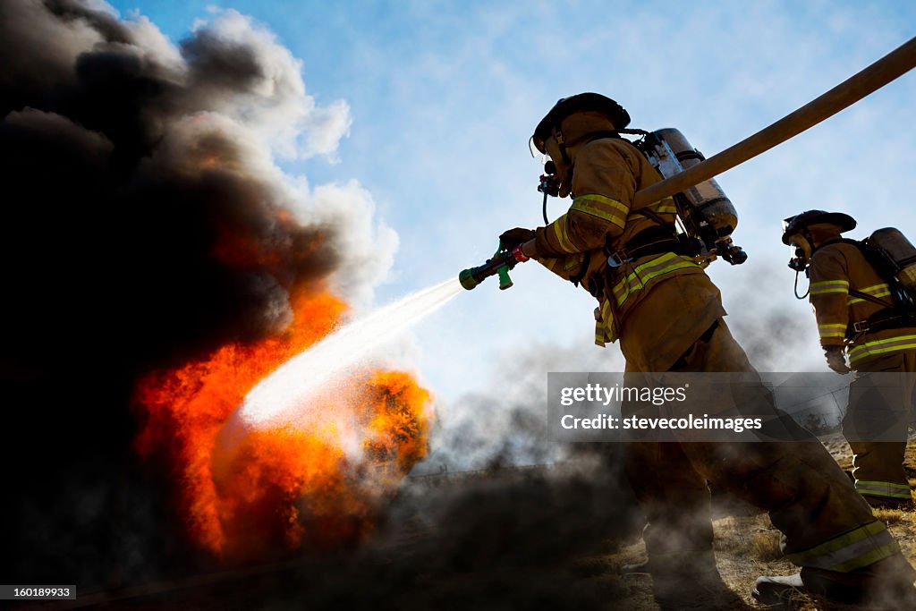 Firefighters Extinguishing House Fire