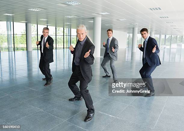 businessmen practicing t'ai chi - kung fu pose stock pictures, royalty-free photos & images