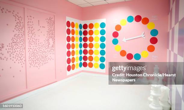 Magnetic board with pink Scrabble tiles and a wall-mounted Twister game, next to giant chess pieces in the "game room", one of several themed rooms...