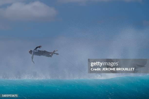 Surfer Kelly Slater jumps into the water at Teahupo'o in Tahiti, French Polynesia on August 15 during WSL Shiseido Tahiti pro surfing event....