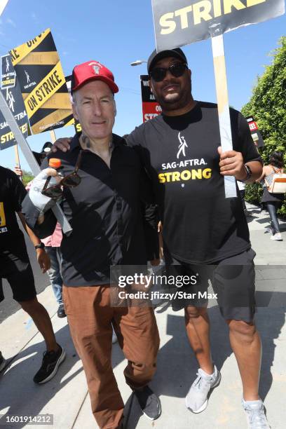 Bob Odenkirk and Cedric Yarbrough walk the picket line in support of the SAG-AFTRA and WGA strike at Paramount Studios on August 15, 2023 in...