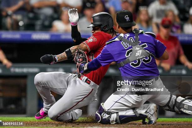 Elias Diaz of the Colorado Rockies tags out Gabriel Moreno of the Arizona Diamondbacks to end the top of the seventh inning at Coors Field on August...