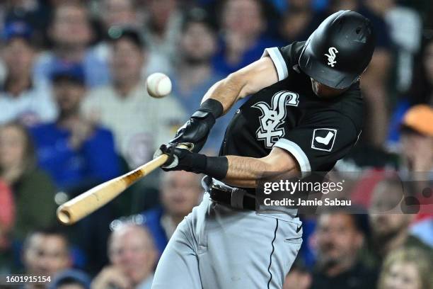 Andrew Benintendi of the Chicago White Sox hits an RBI double in the ninth inning against the Chicago Cubs at Wrigley Field on August 15, 2023 in...