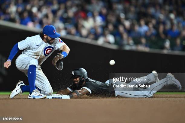 Elvis Andrus of the Chicago White Sox steals second base in the ninth inning as Dansby Swanson of the Chicago Cubs takes the throw at Wrigley Field...