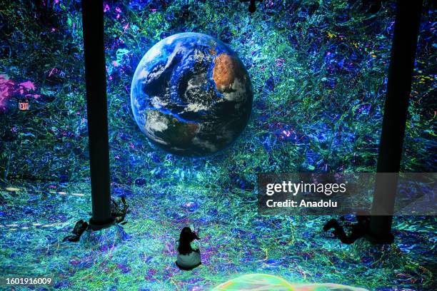 People visit Beyond the Light Exhibition, included visuals obtained from the James Webb Space Telescope, in New York, United States on August 15,...