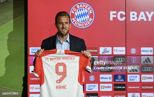 Bayern Munich's English forward Harry Kane poses with his jersey during a press conference on his presentation after signing a four-years deal with...