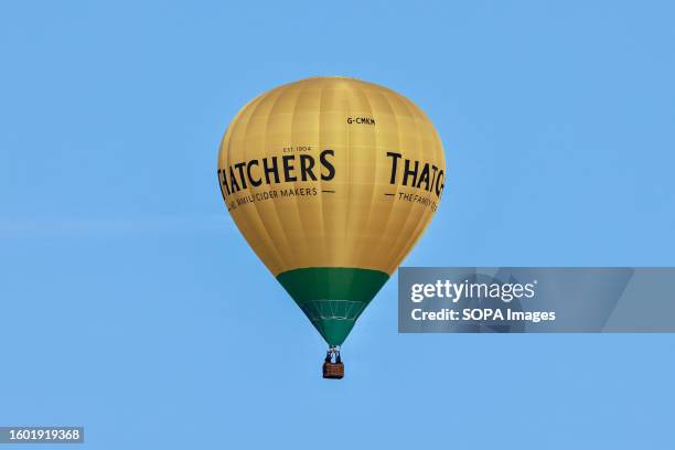 Balloon with a Thatcher's cider logo seen during the festival. Bristol International Balloon Fiesta is Europe's largest hot air balloon meeting,...