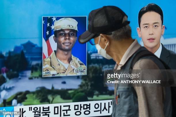 In this photo taken in Seoul on August 16 a man walks past a television showing a news broadcast featuring a photo of US soldier Travis King , who...