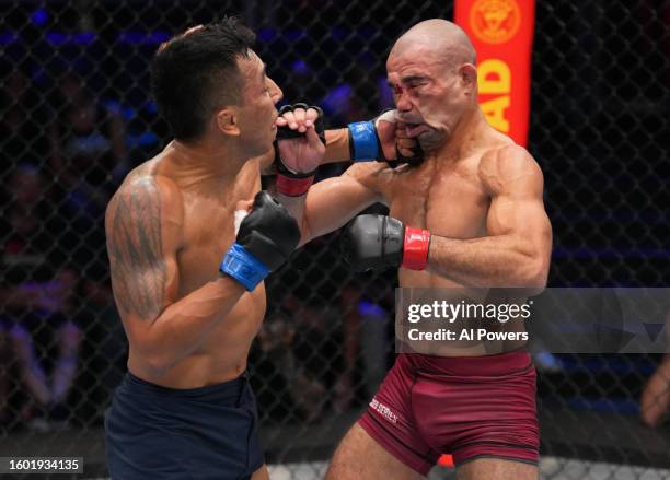 Kevin Borjas of Peru punches Victor Dias of Brazil in a flyweight fight during Dana White's Contender Series season seven, week one at UFC APEX on...