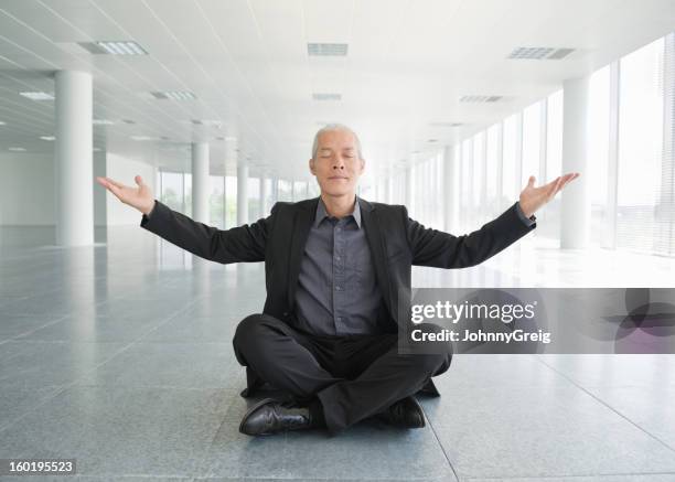 business zen - businessman meditating stock pictures, royalty-free photos & images