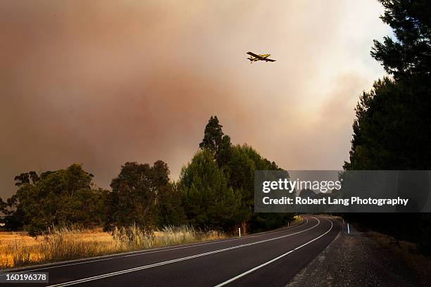 20th November 2012, Coomunga, Eyre Peninsula: A fully loaded Country Fire Service fixed winged water bombing plane flys over the Lincoln highway, a...