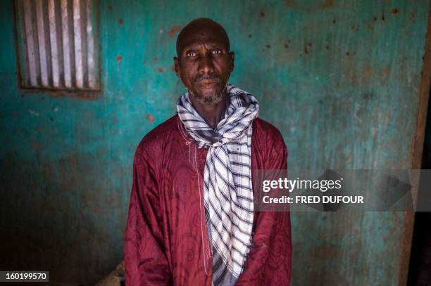 Laurence BOUTREUX - Idrissa Maiga, a Malian farmer, poses in his house in Konna on January 27, 2013. Maiga's second wife and two boys and a girl aged...