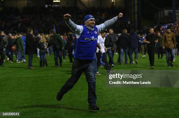 Oldham fans celebrate victory at the end of the FA Cup with Budweiser Fourth Round match between Oldham Athletic and Liverpool at Boundary Park on...