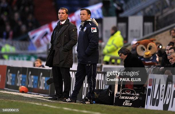 Liverpool manager Brendan Rodgers and Oldham Athletic manager Paul Dickov watch during the English FA Cup fourth round football match between Oldham...