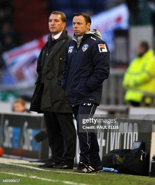 Liverpool manager Brendan Rodgers and Oldham Athletic manager Paul Dickov watch during the English FA Cup fourth round football match between Oldham...