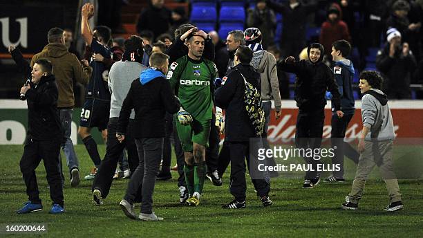 Oldham Athletic's Australian goalkeeper Dean Bouzanis celebrates after their 3-2 win in the English FA Cup fourth round football match between Oldham...