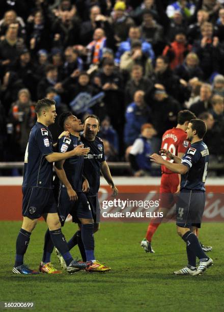 Oldham Athletic's Reece Wabara is congratulated by teammates after scoring the team's third goal during their 3-2 win in the English FA Cup fourth...