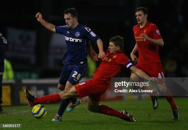 Jose Baxter of Oldham competes with Steven Gerrard of Liverpool during the FA Cup with Budweiser Fourth Round match between Oldham Athletic and...