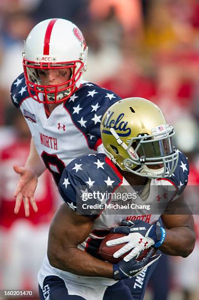 Quarterback Mike Glennon hands the ball off to running back Johnathan Franklin of the North Team on January 26, 2013 at Ladd-Peebles Stadium in...