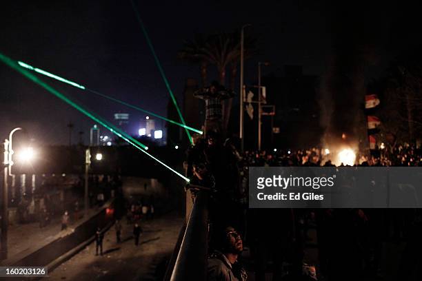 Egyptian protesters gather together during clashes with riot police near Tahrir Square on January 27, 2013 in Cairo, Egypt. Violent protests...