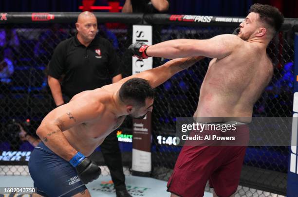 Caio Machado of Brazil punches Kevin Szaflarski of Austria in a heavyweight fight during Dana White's Contender Series season seven, week one at UFC...