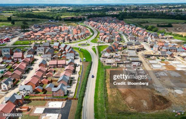 Residential housing construction sites alongside new homes in Hugglescote, UK, on Tuesday, Aug. 15, 2023. UK house prices have fallen just 1.7% from...