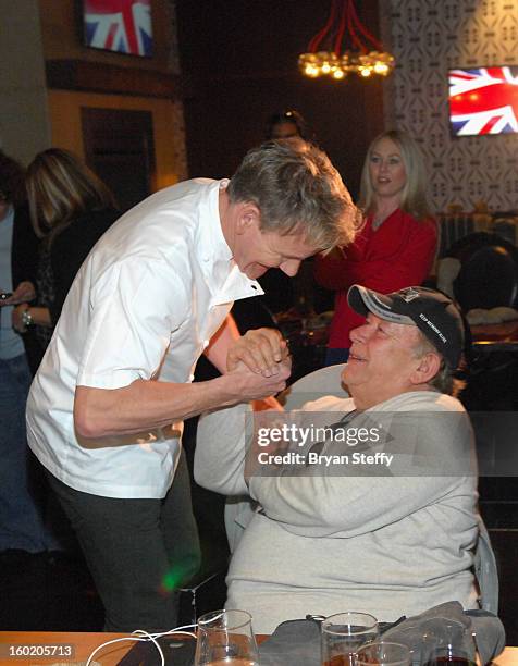 Television personality and chef Gordon Ramsay greets television host and writer Robin Leach during a traditional Sunday Roast at Gordon Ramsay Pub &...