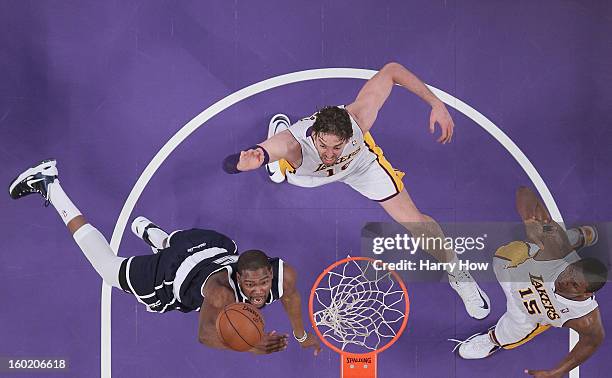 Kevin Durant of the Oklahoma City Thunder scores on a layup in front of Pau Gasol and Metta World Peace of the Los Angeles Lakers during a 106-95...