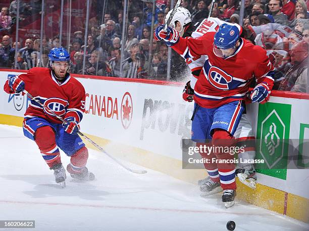 Erik Cole of the Montreal Canadiens colides with Mark Fayne of the New Jersey Devils in the corner as David Desharnais looks on during the NHL game...