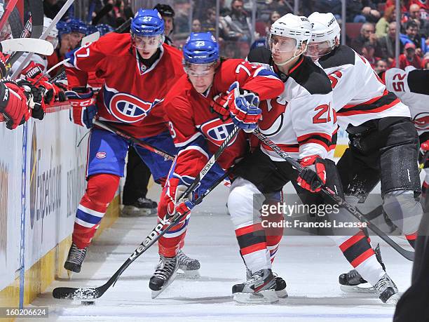 Brendan Gallagher of the Montreal Canadiens tries to fight the puck past Mattias Tedenby of the New Jersey Devils during the NHL game on January 27,...