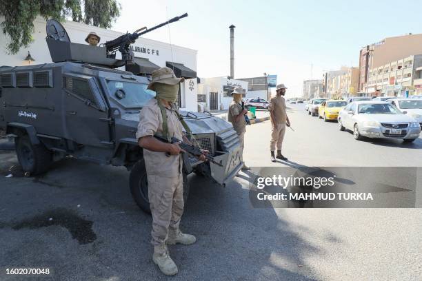 Forces affiliated with the Tripoli-based Government of National Unity deploy following two days of deadly clashes between two rival groups in Libya's...