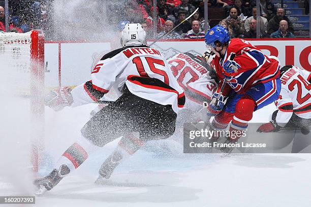 Stephen Gionta of the New Jersey Devils makes a quick stop at the side of his net as Brendan Gallagher of the Montreal Canadiens looks for a loose...