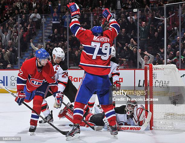 Andrei Markov of the Montreal Canadiens celebrates his overtime winning goal against the New Jersey Devils as goalie Martin Brodeur and Erik Cole...