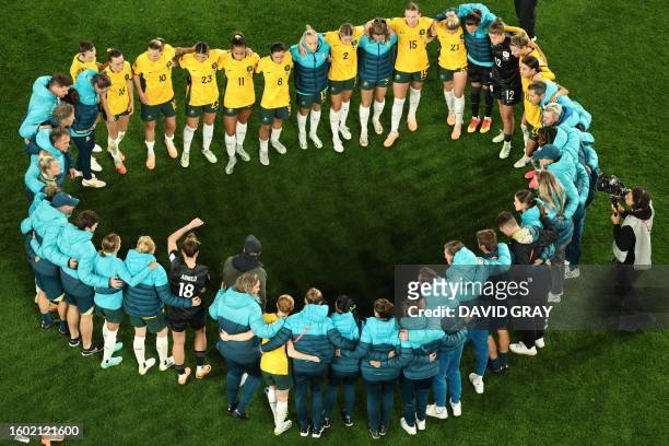 Australia's players gather after losing the Australia and New Zealand 2023 Women's World Cup semi-final football match between Australia and England...