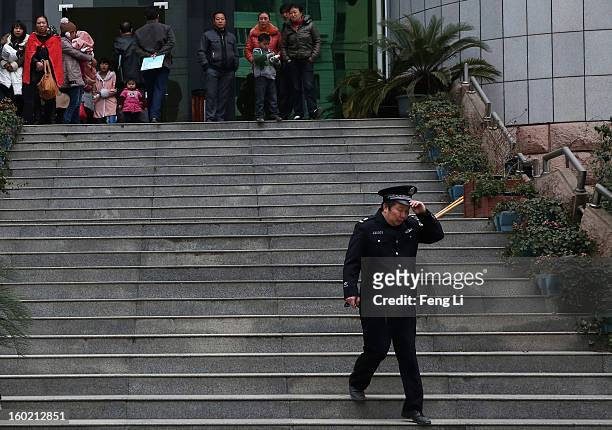 Policeman walks out Guiyang Intermediate People's Court before a press conference on former Chinese leader Bo Xilai's case on January 28, 2013 in...