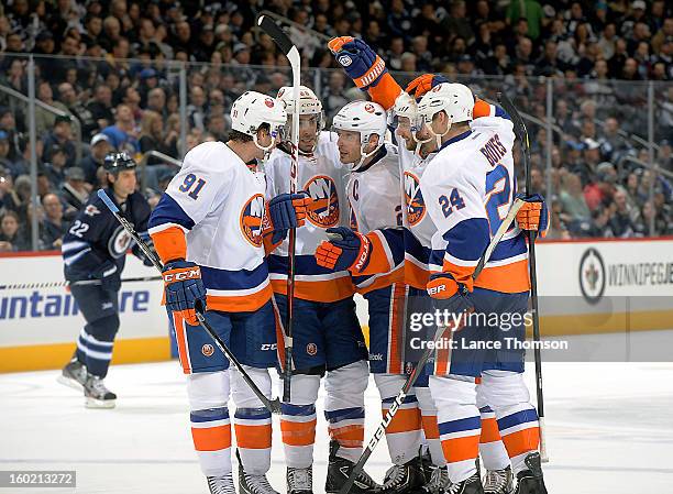 John Tavares, Matt Moulson, Mark Streit, Frans Nielsen and Brad Boyes of the New York Islanders celebrate a third period goal against the Winnipeg...