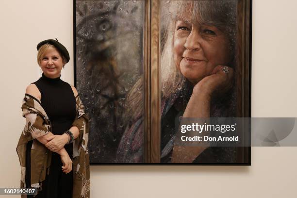 Jaq Grantford poses in front of her Archibald People's Choice Award winning portrait of Noni Hazelhurst titled 'Through the Window' at the winner's...