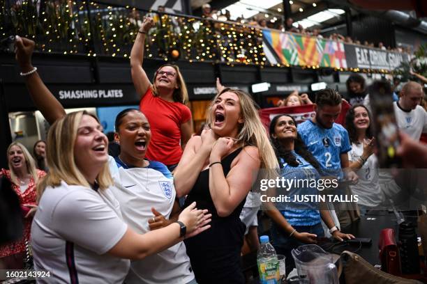 England fans celebrate the victory of England as they watch a screen showing the Women's World Cup semi-final football match between Australia and...