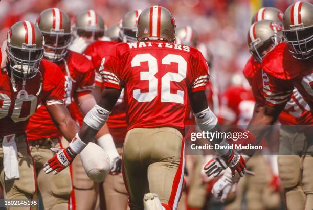 Ricky Watters of the San Francisco 49ers is greeted by 49ers teammates prior to a National Football League game against the Buffalo Bills played on...