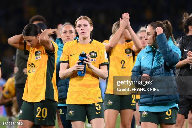 Australia's players react after losing the Australia and New Zealand 2023 Women's World Cup semi-final football match between Australia and England...