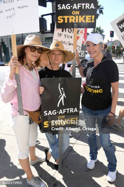 Michelle Forbes, Tara Buck and Nana Visitor walk the picket line at Paramount Studios on August 08, 2023 in Los Angeles, California. Members of...