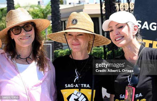 Michelle Forbes, Tara Buck and Nana Visitor walk the picket line at Paramount Studios on August 08, 2023 in Los Angeles, California. Members of...