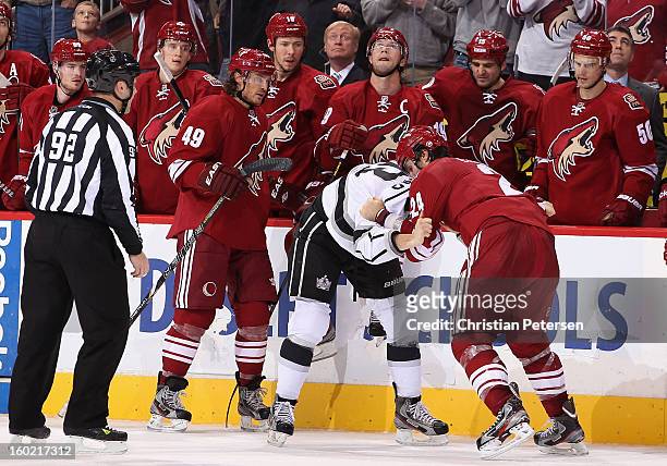 Kyle Clifford of the Los Angeles Kings fights with Kyle Chipchura of the Phoenix Coyotes during the second period of the NHL game at Jobing.com Arena...