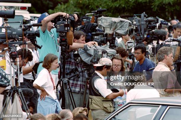 Photographers, television crews and reporters set up on July 31 in Atlanta, outside the apartment of Richard Jewell, a security officer who is being...