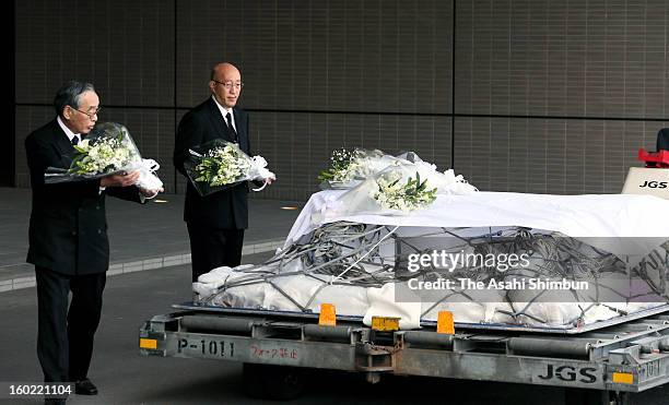 Japanese plant construction company JGC Co president Koichi Kawana offers a flower bunch on the coffin of their supreme advisor Tadanori Aratani, who...