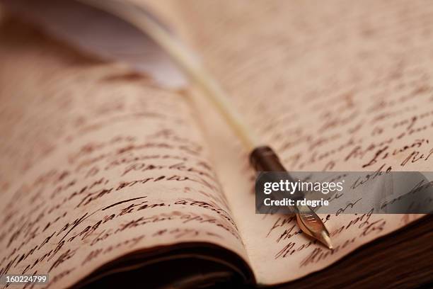 close-up of vintage journal and quill pen - quill pen stock pictures, royalty-free photos & images