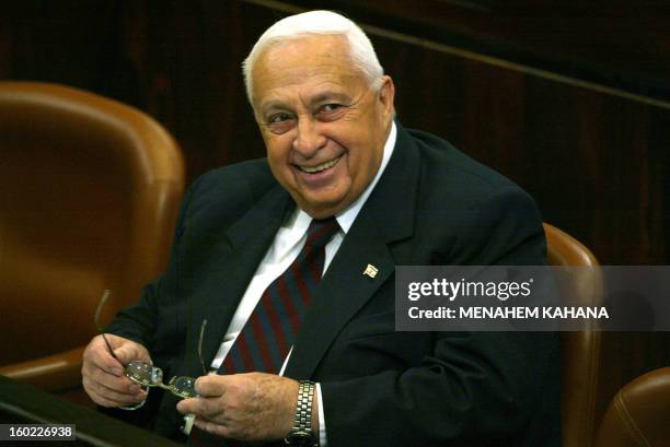 Israeli Prime Ariel Sharon smiles during a Knesset session in Jerusalem 21 January 2004. A corruption scandal threatened to engulf the household of...